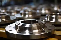 Customized steel flanges and fasteners in a factory.
